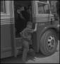 Photograph: [Raymond Clark boarding a bus]