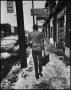 Thumbnail image of item number 1 in: '[Man walking down a snowy sidewalk]'.