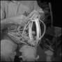 Photograph: [Photograph of a man starting the weave on a basket]