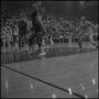 Photograph: [Basketball player falling from mid-air with the ball in his hands]