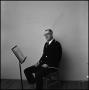 Photograph: [Maurice McAdow sitting in a chair, 3]