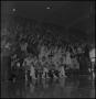 Photograph: [Basketball players on the bench, watching the game]