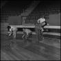 Photograph: [Basketball coaches installing coliseum floor]