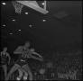 Photograph: [Basketball players compete for the ball]