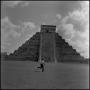 Photograph: [A man running in front of a step pyramid]