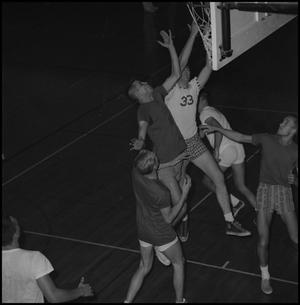 Primary view of object titled '[Basketball players jump for a rebound]'.