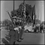 Photograph: [Uniformed flag-bearers in a line, one holding a rifle]