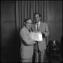 Primary view of [President Nolen presenting an award to Dr. Clayton Scott]