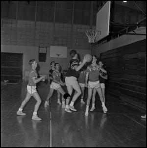 Primary view of object titled '[Basketball player shooting the ball at an intramural game, 3]'.