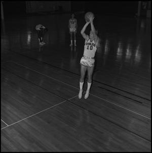 Primary view of object titled '[Basketball players on the court practicing]'.