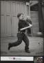 Photograph: [Junebug Clark Playing Baseball in an Alley]