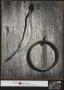 Photograph: [Metal ring mounted to wood]