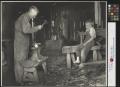Photograph: [Unidentified blacksmith working in his shop]