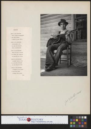 Primary view of object titled '[Photo of a man playing guitar on a porch]'.