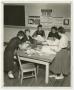 Photograph: [Six female students working at a table for wise buying]