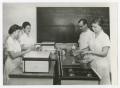 Thumbnail image of item number 1 in: '[Four students in classroom cooking]'.