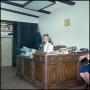 Photograph: [Woman sits at an office desk]
