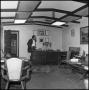 Photograph: [Rex Cauble, dog, and associate in office]