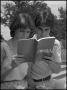 Photograph: [Rosemary and Max Bruchwald reading catalog]