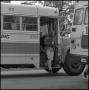 Photograph: [Student stepping out of bus]