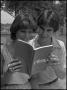 Photograph: [Rosemary and Max Bruchwald reading a course catalog]