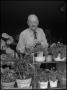 Photograph: [Garland Brookshear standing with plants]