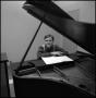 Photograph: [Bill Blaine sitting and resting arms on piano 1]