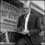 Photograph: [Dr. Earle Blanton holding tool in workshop]