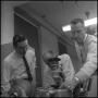 Photograph: [Biology researchers inspect microscope 1]
