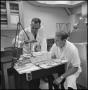 Photograph: [Two researchers experimenting in lab]