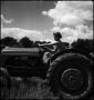 Photograph: [Young man driving a tractor]