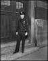 Photograph: [Uniformed man standing on a step]