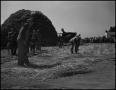 Photograph: [Two men threshing wheat with flails]
