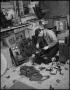 Photograph: [Man repairing a telephone, 2]