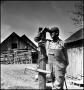 Photograph: [Farmer standing by a wooden post, 3]