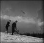 Photograph: [Two skiers and their dog]
