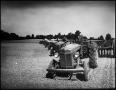Photograph: [Seven tractors plowing a field]