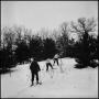 Photograph: [Three people skiing up a hill]