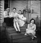 Photograph: [Five people sitting on their front steps]