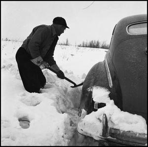 Primary view of object titled '[Man shoveling his car out of the snow, 4]'.