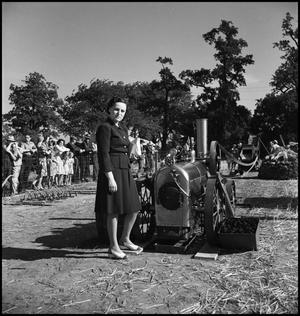Primary view of object titled '[Woman standing next to a machine]'.