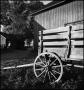 Photograph: [Farm wagon outside of a barn]