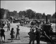 Photograph: [Crowds of people watching people and horses work]