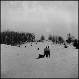Primary view of object titled '[Two people dragging a sled up a hill]'.