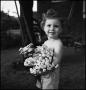 Photograph: [Portrait of a little girl holding a bouquet of flowers]
