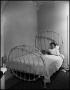 Photograph: [Woman lying in a bed]