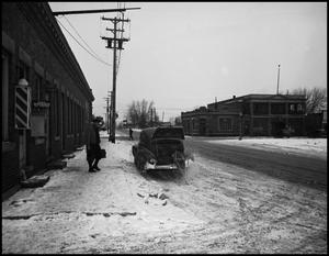Primary view of object titled '[Car idling outside of the Western Union telegram office]'.
