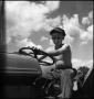 Photograph: [Boy driving a tractor]