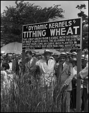 Primary view of object titled '[Three men standing underneath the "Dynamic Kernels" sign]'.