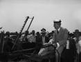Photograph: [Henry Ford driving an old mechanical reaper]